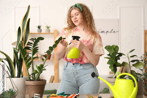 Young woman spraying green ...