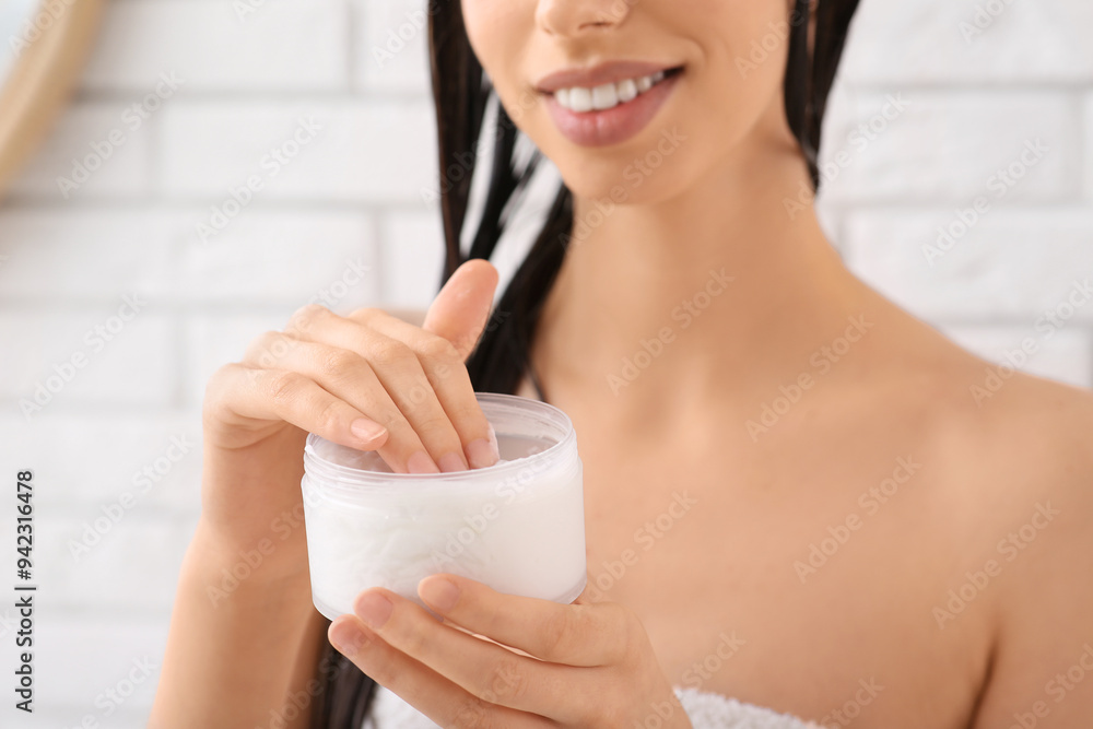 Beautiful young happy woman with jar of hair mask in bathroom, closeup Beautiful young happy woman with jar of hair mask in bathroom, closeup
