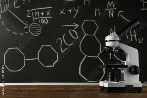 Modern microscope on wooden...