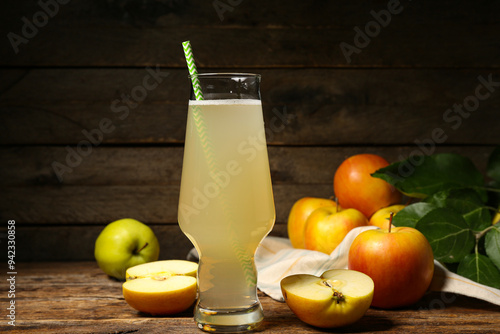 Glass of fresh apple kvass and fruits on wooden background photo