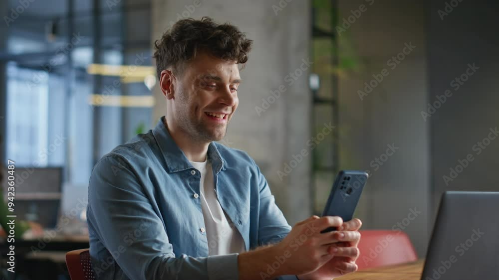 Laughing ceo browsing internet getting funny sms mobile phone in office closeup Laughing ceo browsing internet getting funny sms mobile phone in office closeup