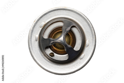Studio photography of an engine coolant thermostat isolated on a white background. Top view of used car component for vehicle engine. Close-up shot, spare parts for service and maintenance.