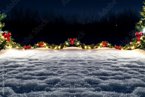 Golden and red Christmas ornaments in the snow with holiday lights in the background. Great for festive designs. photo