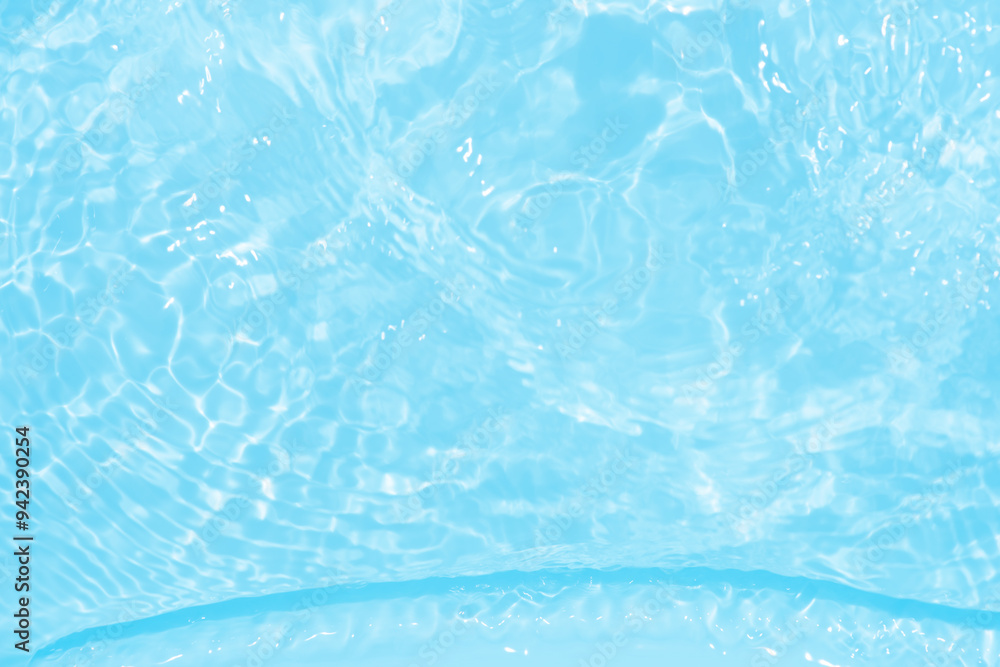 Blue water with ripples on the surface. Defocus blurred transparent blue colored clear calm water surface texture with splashes and bubbles. Water waves with shining pattern texture background. Blue water with ripples on the surface. Defocus blurred transparent blue colored clear calm water surface texture with splashes and bubbles. Water waves with shining pattern texture background.