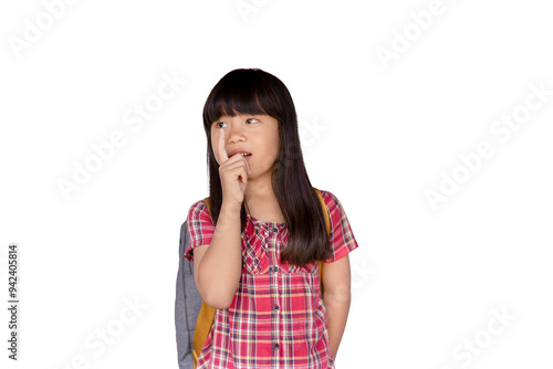 Happy little Asian girl Looking and pointing sideways while standing on a white background in a cute, relaxed, fun, carefree pose. Concept of happiness.