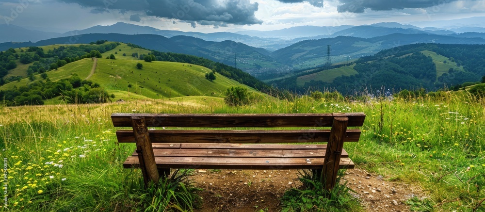 Fototapeta premium Wooden Bench For Sitting With Nice View To Hills Landscape Scenery