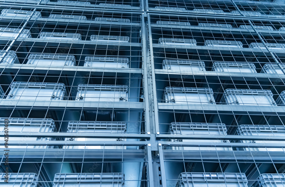 plastic boxes in the cells of the automated warehouse. Metal construction warehouse shelving plastic boxes in the cells of the automated warehouse. Metal construction warehouse shelving