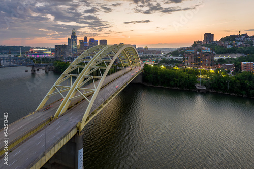 Slika na platnu Cincinnati, Ohio with driving cars on Daniel Carter Beard Bridge highway near illuminated high skyscraper buildings in downtown district in USA