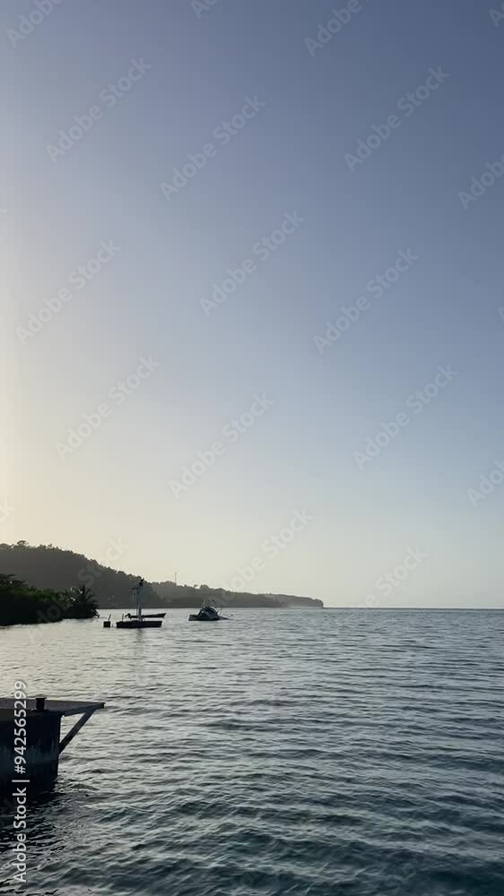 Sunset over the coast from a pier. Port Antonio, Portland, Jamaica Sunset over the coast from a pier. Port Antonio, Portland, Jamaica