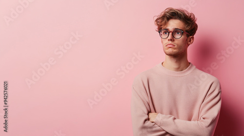 Portrait of a jaded young caucasian man isolated on pink background with copy space photo