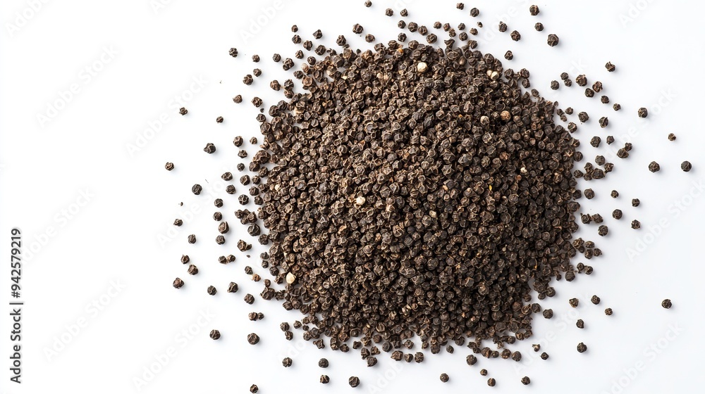 Close-Up of Black Peppercorns Scattered on a White Background Close-Up of Black Peppercorns Scattered on a White Background
