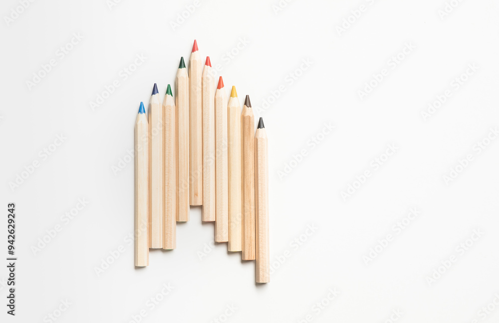 Set of natural wood-colored pencils neatly arranged in a row, showcasing a variety of colors on a clean white background.Ideas for concepts of creativity and art education Set of natural wood-colored pencils neatly arranged in a row, showcasing a variety of colors on a clean white background.Ideas for concepts of creativity and art education