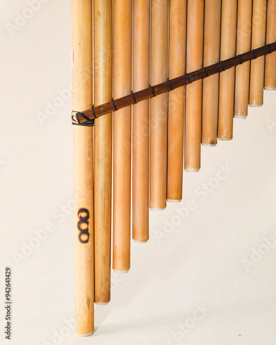 Male hands holding a rondador on a beige isolated background. Andean instrument, pan flute, traditional South American instrument. photo