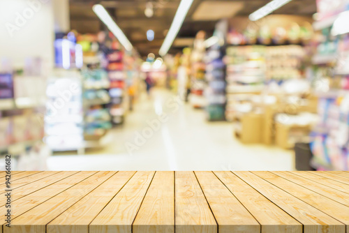 Empty wood table top with supermarket blurred background for product display