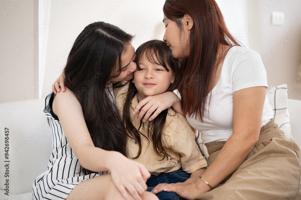 Mother and daughter hug with kissing to little daughter with little daughter smiling at home Mother and daughter hug with kissing to little daughter with little daughter smiling at home