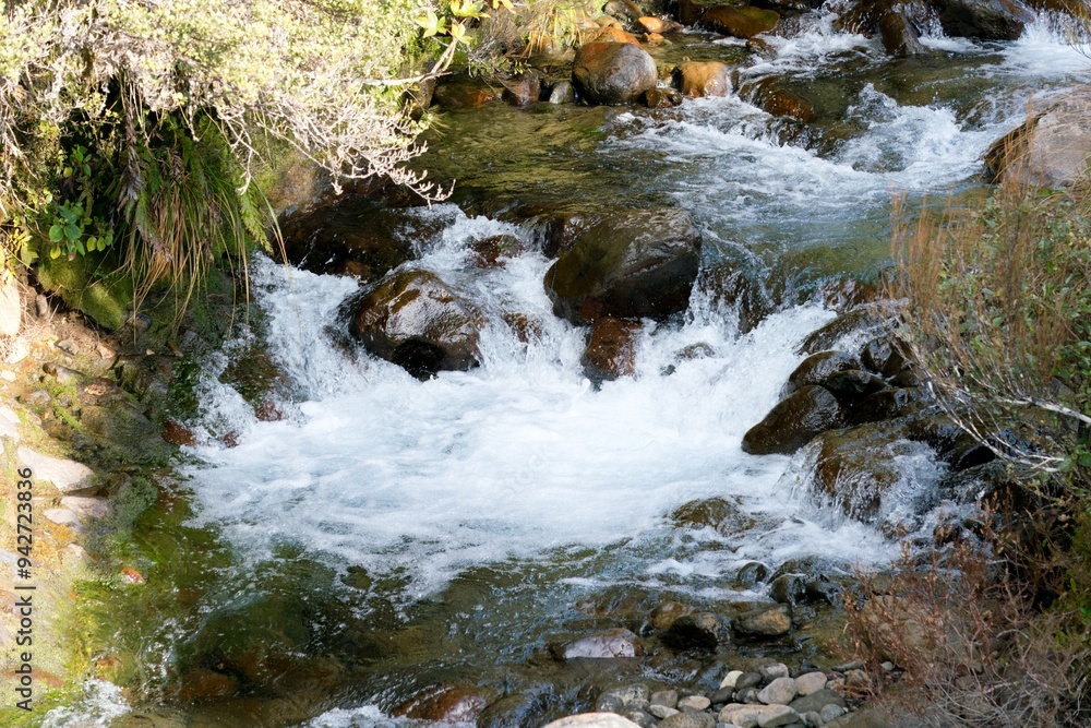 Water flows over the rusty brown rocks at The Silica Rapids Water flows over the rusty brown rocks at The Silica Rapids