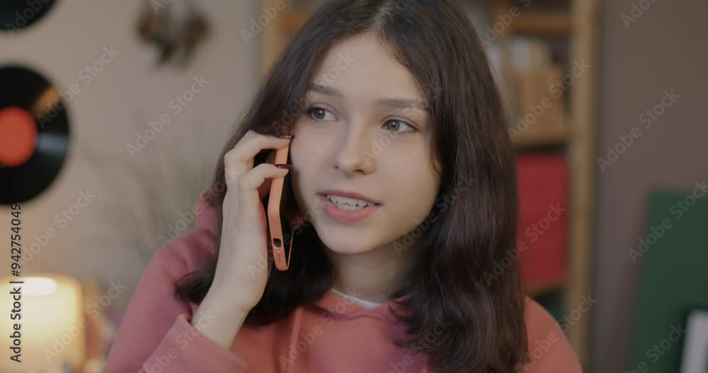 Happy teenage girl speaking on mobile phone sharing good news smiling indoors at home. Cellphone communication and teen lifestyle concept. Happy teenage girl speaking on mobile phone sharing good news smiling indoors at home. Cellphone communication and teen lifestyle concept.
