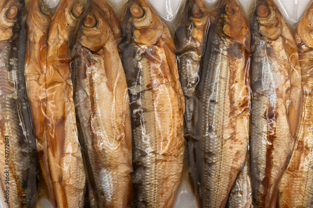 Obraz premium Vacuum packaged smoked fish texture background.