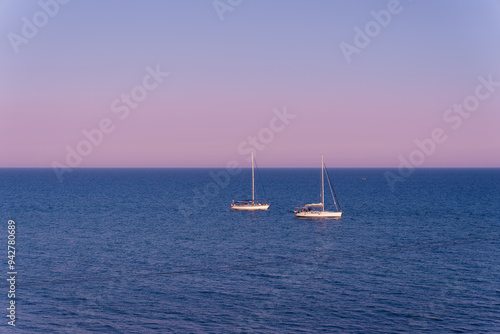 Quiet sea and yachts at dusk