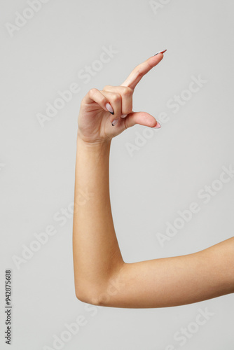 Woman's Arm Extended With Hand Open and Fingers Against a White Background