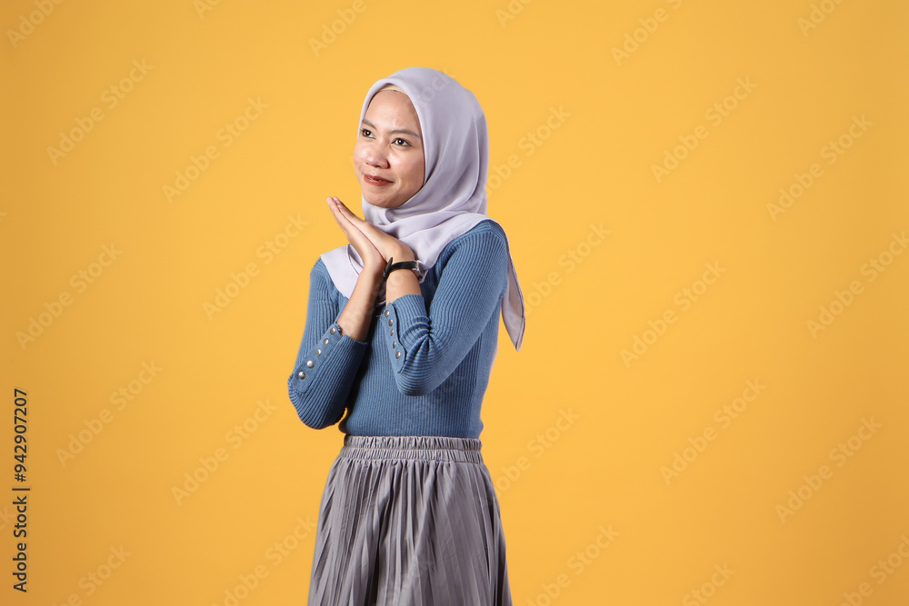 happy asian indonesian muslim women with hope hand gesture on isolated yellow background happy asian indonesian muslim women with hope hand gesture on isolated yellow background