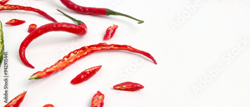 A group of fresh, vibrant red chili peppers with a distinctive curly shape, isolated on a white background with plenty of copy space for your text. photo