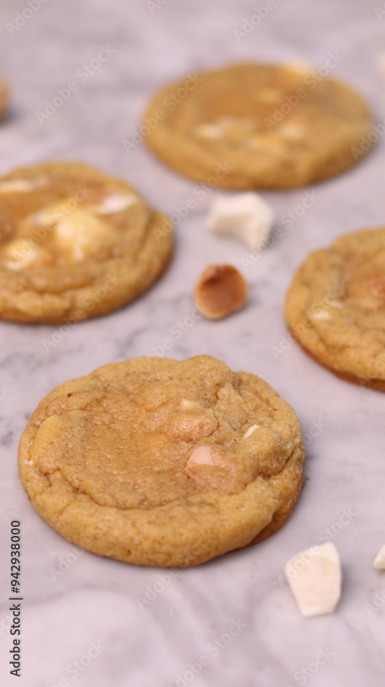 The cookies are golden brown with a slightly crispy edge and a soft, chewy center. Some cookies have chocolate chips The cookies are golden brown with a slightly crispy edge and a soft, chewy center. Some cookies have chocolate chips