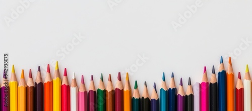 Row of colored pencils on a white background