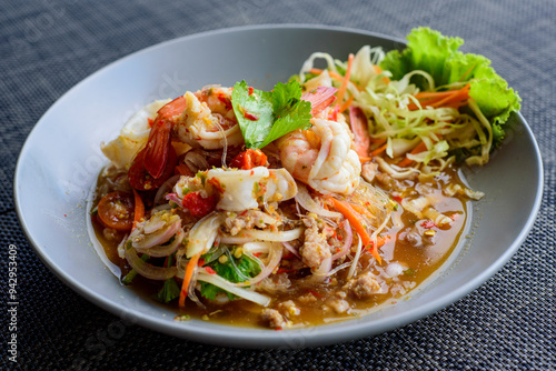 Thai food menu Close-up, Spicy glass noodle salad with pork , shrimp, squid.