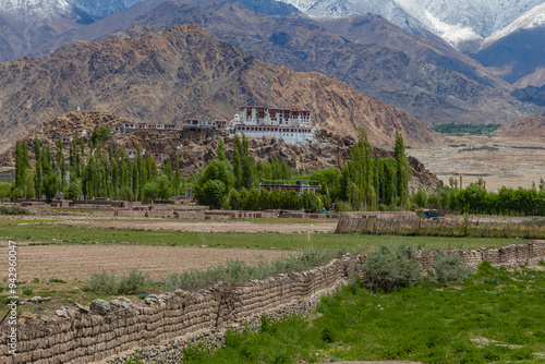 A distant view of Stakna Monastery with snow-clad mountains in the background in Ladakh. Clicked on 20 May 2023. photo