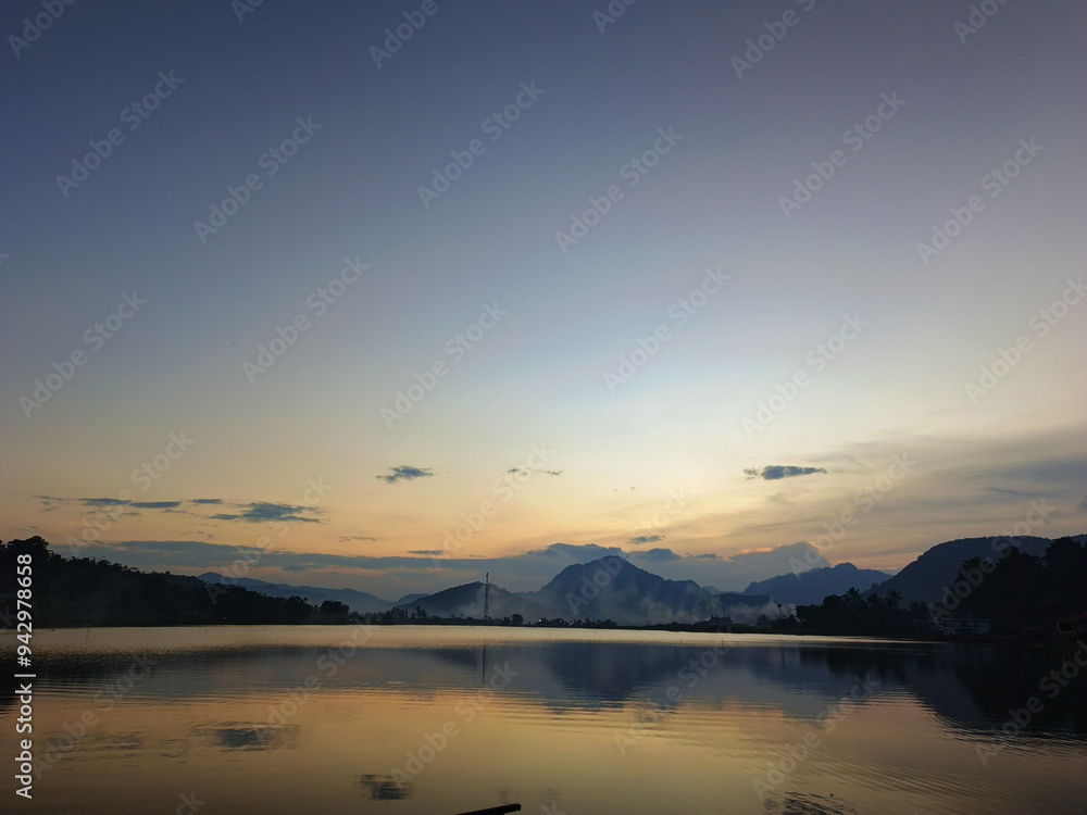 reflection of the evening sunset on a beautiful lake background with a blue orange sky reflection of the evening sunset on a beautiful lake background with a blue orange sky
