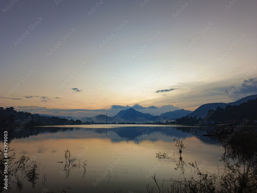 reflection of the evening sunset on a beautiful lake background with a blue orange sky reflection of the evening sunset on a beautiful lake background with a blue orange sky