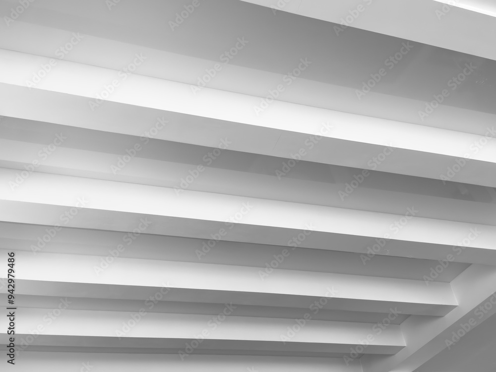 Obraz premium Suspended and grid ceiling with LED spots lamps and drywall construction in empty room in house interior. Stretch ceiling white and complex shape.