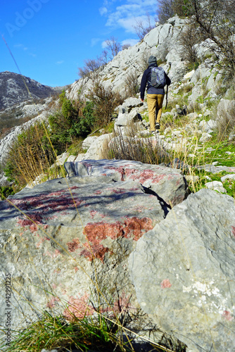 Photographed from the back of a tourist walking along an old mountain road in the vicinity of Orahovac. Hiking in the mountains of the Bay of Kotor - picturesque routes on the coast of Montenegro. photo