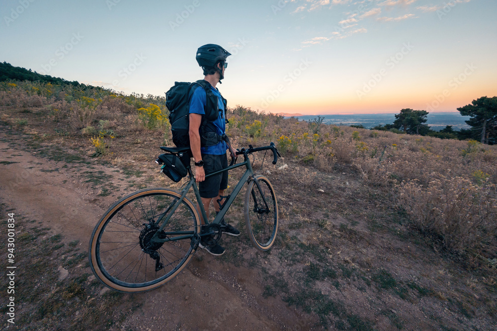 Man enjoying a sunset gravel bike ride in nature Man enjoying a sunset gravel bike ride in nature
