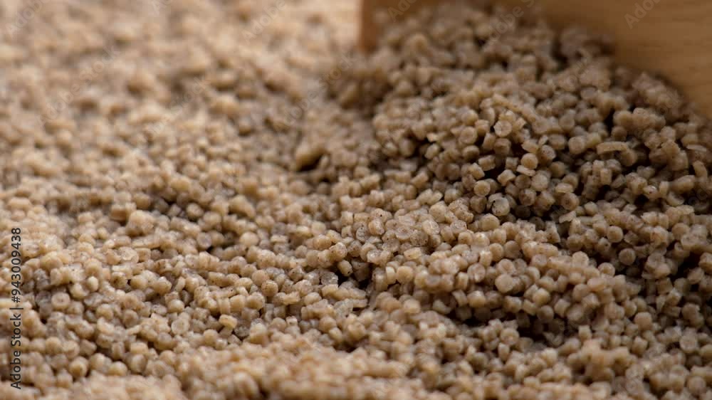 Ready to eat cooked buckwheat couscous. Nutritious grain porridge in wooden spoon close up Ready to eat cooked buckwheat couscous. Nutritious grain porridge in wooden spoon close up