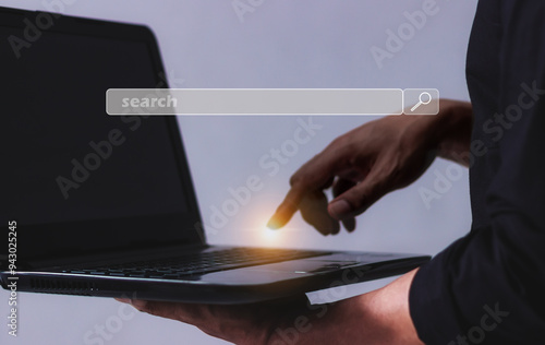 Young man hand with laptop touching search bar, Search job photo