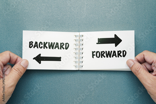 Фотография Closeup hand taking an opened notepad on the desk, make a decision to turn the p