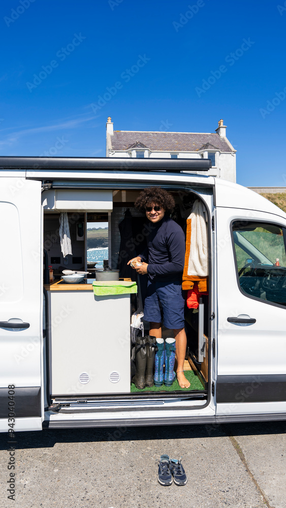 A man enjoys summer vacation in a camper van A man enjoys summer vacation in a camper van