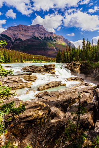 Waterfalls in the rocky mountains. Picturesque Athabasca Falls with Mount Kerkeslin in the background.  Jasper National Park, Alberta, Canada photo