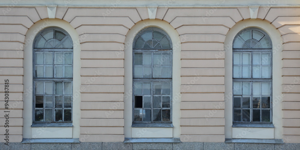Three arched windows on the ground floor of the house Three arched windows on the ground floor of the house