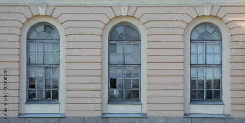 Three arched windows on the ground floor of the house