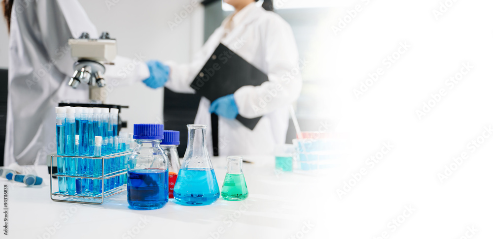 Scientist mixing chemical liquids in the chemistry lab. Researcher working in laboratory Scientist mixing chemical liquids in the chemistry lab. Researcher working in laboratory
