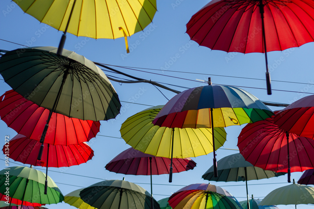 A row of colorful bright umbrellas an alley of shops in Adler (Sochi).