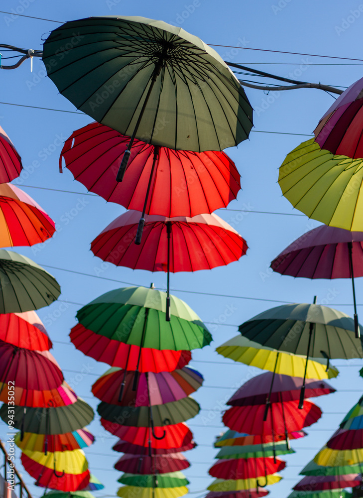 A row of colorful bright umbrellas an alley of shops in Adler (Sochi).
