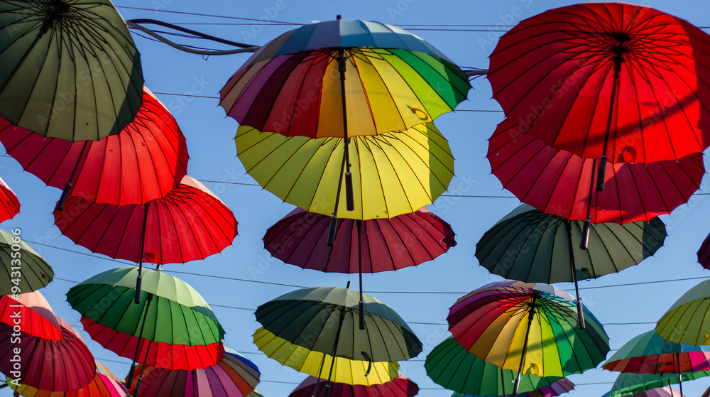 A row of colorful bright umbrellas an alley of shops in Adler (Sochi).