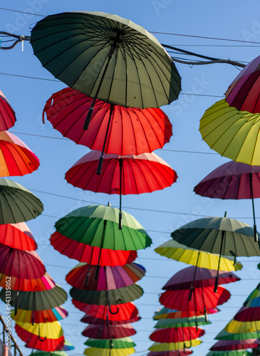 Obraz na płótnie A row of colorful bright umbrellas an alley of shops in Adler (Sochi). w salonie