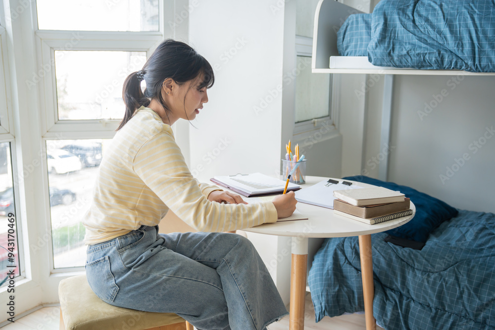Student asian woman reading book in dorm room college student do homework in university dormitory