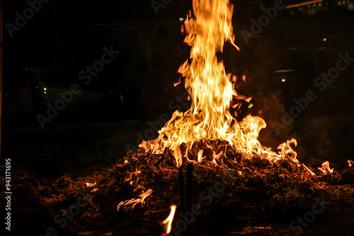 Chinese hungry ghost festival prayer offering joss paper money candle burning fire flame smoke