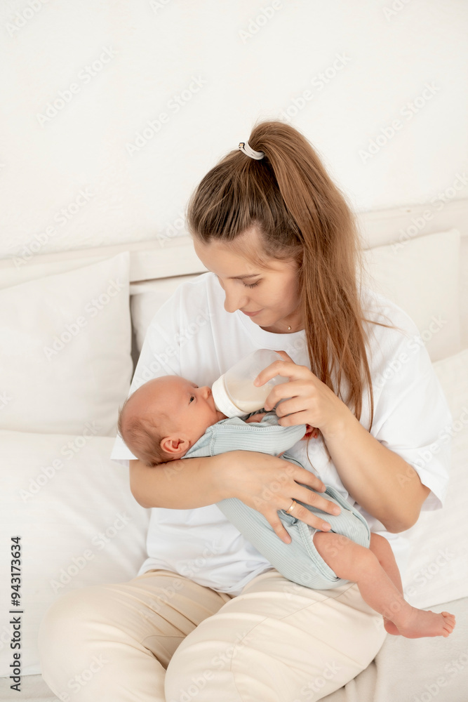 feeding a baby from a bottle, a mother feeds a newborn baby with milk while holding it in her arms, baby food, a baby sucks a bottle feeding a baby from a bottle, a mother feeds a newborn baby with milk while holding it in her arms, baby food, a baby sucks a bottle